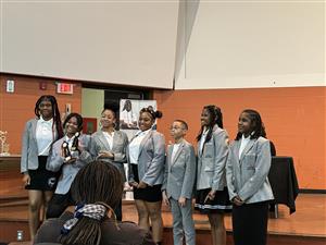 The debate team receiving their awards